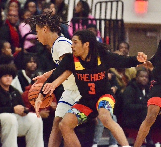 Ewing’s Woo Cannon, left, tries to spin away from the...