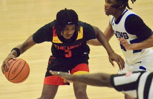 Trenton High’s Aivaye Ingram, left, dribbles the ball up the...