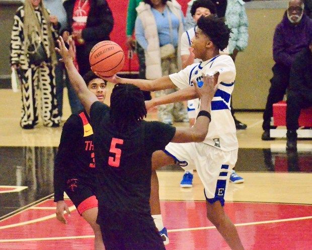Ewing’s Jeremiah Upshur, right, lays the ball in the basket...